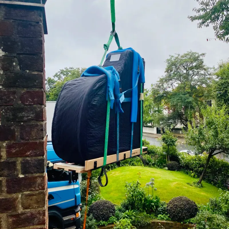 Grand piano delivered by lorry-mounted crane