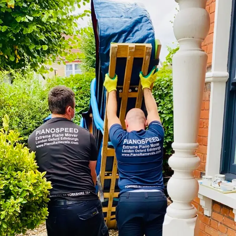 PianoSpeed crew loading a piano onto a dolly